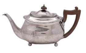A George III silver tea pot, rounded oblong, with a gadroon border,