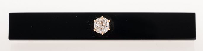 An early 20th century diamond bar brooch, the elongated rectangular black bar, (possibly Onyx),