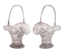 A pair of late 19th/ early 20th century German silver swing-handled bonbon baskets,