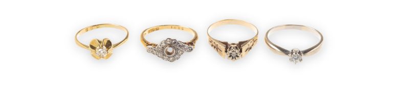 A group of four rings of varied design, including a ring, the mount in the form of a flowerhead,