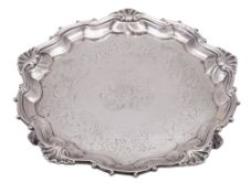 A William IV silver salver, of shaped circular outline, with a husk & scroll border,