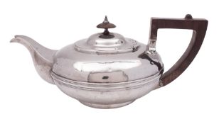 A William IV silver tea pot, of squat circular form, with a reeded girdle and an angular handle,