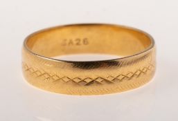An 18ct gold wedding band, with engraved pattern, (faint/worn), indistinct UK hallmark, size S1/2,