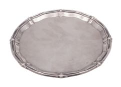 A George V small silver salver or tray, of shaped circular outline,