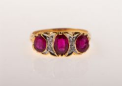 A ruby and diamond three stone ring, collet and grain set with three oval-cut rubies,
