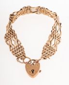 A gate bracelet with heart padlock, some links with carved decoration, some damaged/broken links,