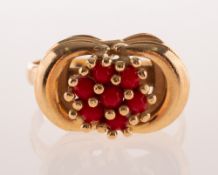 A vintage Italian coral ring, the openwork ring, claw set with a flowerhead design with coral beads,