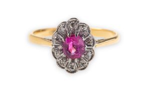 A ruby and diamond cluster ring, the cluster of oval form with a scalloped edge,