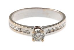 A diamond ring, claw and raised set to the centre with a brilliant-cut diamond, diamond approx. 0.