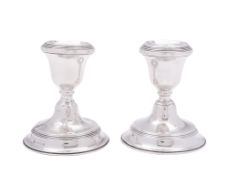A pair of George V silver dwarf candlesticks, circular form, with reeded borders and loaded bases,