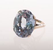 A synthetic blue spinel cocktail ring, claw set with an oval mixed-cut synthetic blue spinel,