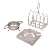 A small mixed lot of silver, to include a toast rack, a tea strainer and an ashtray,