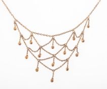 A late Victorian gilt festoon necklace, circa 1890-1905, the fine trace link chain,