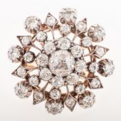 A late Victorian diamond brooch pendant, of openwork flowerhead form,