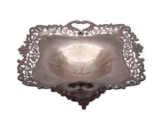 An Edwardian silver fruit dish, of shaped square outline, with a pierced,