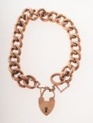 An early 20th century 9ct rose gold curb link bracelet, some links having carved decoration,