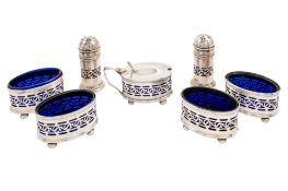 A George V seven-piece silver condiment set, comprising of four salts,