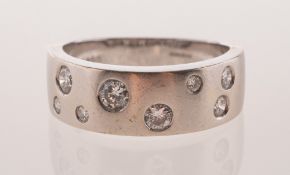 A modern 18ct white gold and diamond ring, of band form with satin finish to the front section,