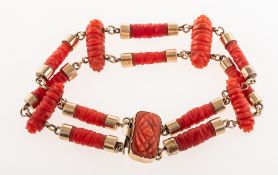 A carved coral bracelet, a double row of tubular shaped foliate carved coral links,