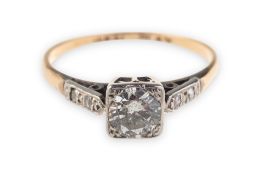 An Art Deco diamond ring, grain set in a square shaped setting with a brilliant-cut diamond,