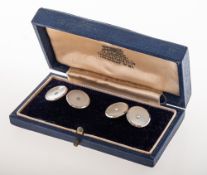 A pair of mother of pearl cufflink's, each set to the centre with a single small split pearl,
