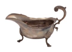 A George V silver sauce boat, oval, with a wavy rim,