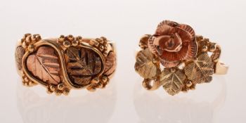 Two 9ct gold floral and foliate varied design rings, each of yellow and rose gold,