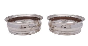 A pair of 20th century silver mounted wine coasters, circular form, with turned wooden inserts,
