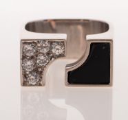 An abstract style diamond and onyx set ring, of split front design,