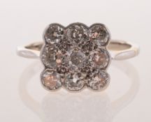 An Art Deco diamond cluster ring, of square form with scalloped edges,