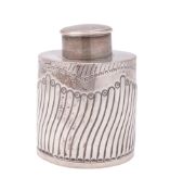 A late Victorian silver tea caddy, cylindrical form, with a wrythen-fluted body and a chased border,
