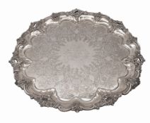 A cased George V large engraved silver salver, of shaped circular outline,