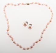 A pink freshwater pearl necklace and clip-on earrings,