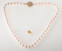 A cultured pearl necklace with a diamond set clasp,
