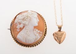A locket and a cameo brooch, a 9ct gold heart shaped locket with foliate carving,
