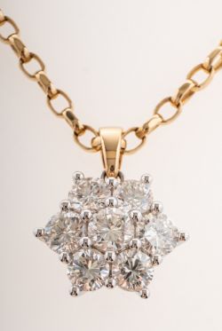 An impressive diamond daisy pendant with chain,