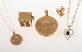 A small mixed collection of jewellery, including a circular triple locket,