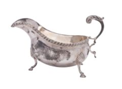 A 20th century silver sauce boat, on three legs,