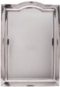 A George V silver mounted wall mirror, shaped rectangular outline,