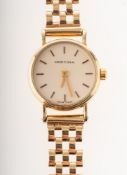 Certina a lady's 9K gold wristwatch the round cream dial having raised baton numerals,