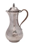 A George II silver hot water jug, of baluster form, with a cane-insulated handle,