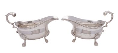 A pair of 20th century silver sauce boats, on three legs,