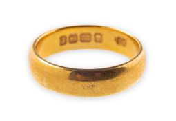 A 22ct gold wedding band, UK hallmark, width approx. 5.0mm, size O, 6.8grams.