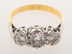 A three stone diamond ring, illusion set with three brilliant-cut diamonds,