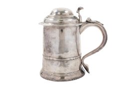 A George I silver tankard, of tapering circular form, with a skirted base,