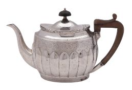 A late Victorian silver tea pot, oval form, with bright-cut engraved borders and frieze,