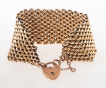 An antique mesh link bracelet, with heart padlock and safety chain,