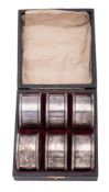 A George V cased set of six silver napkin rings,
