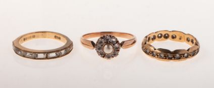 A group of three dress rings of varied design, including a 9ct gold half eternity style ring,