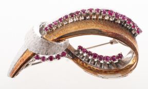 A vintage ruby brooch, in the form of a knotted ribbon loop, textured finish,
